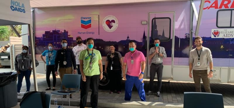 Staff at CrescentCare clinic in New Orleans pose outside the mobile unit they've established to test for COVID-19.